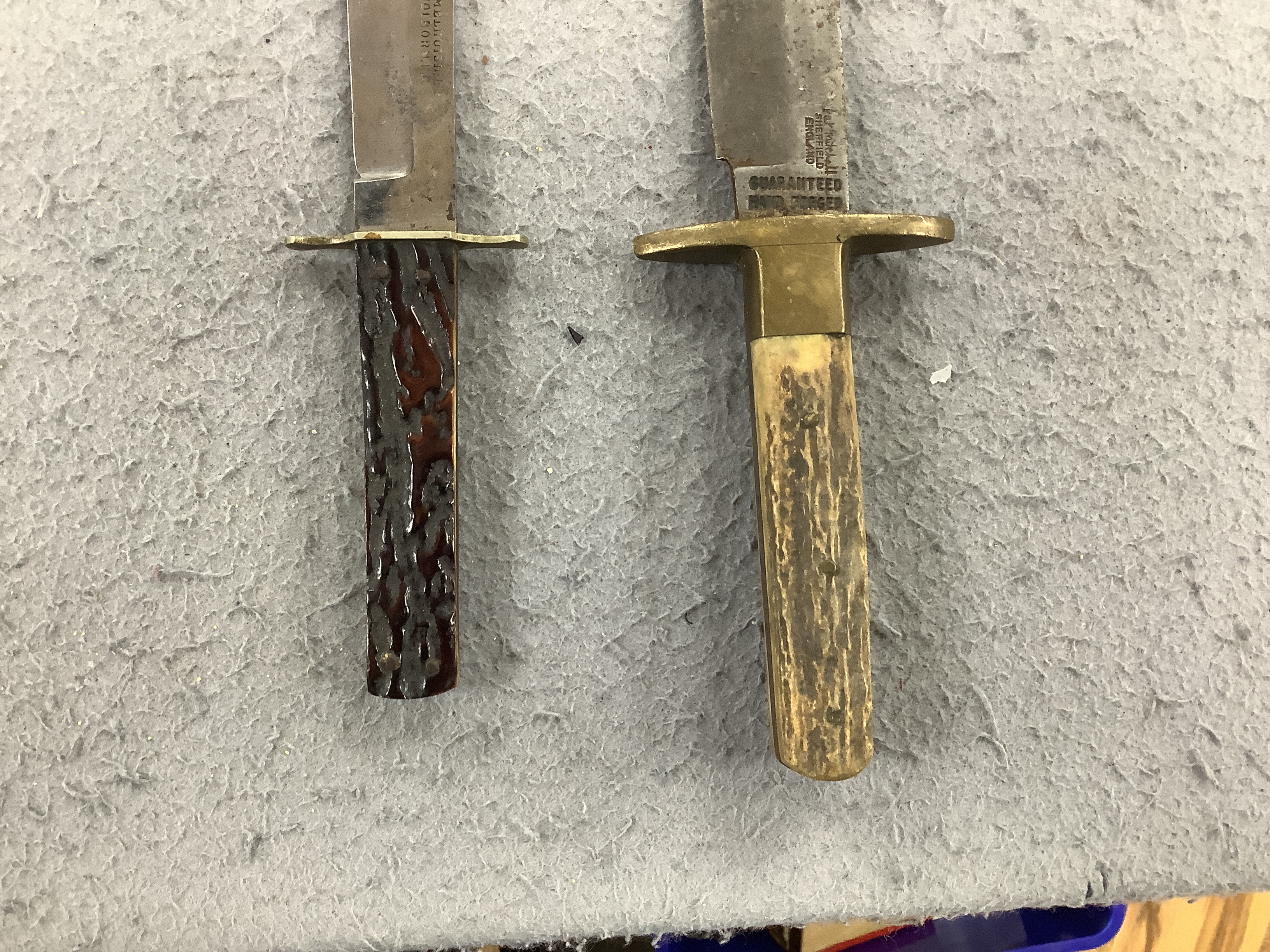 Two antler-handled hunting knives and three other knives